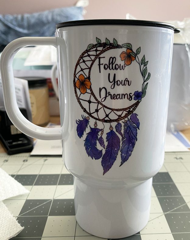 A coffee mug with the words " follow your dreams ".