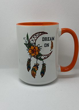 A coffee mug with the words " dream on ".