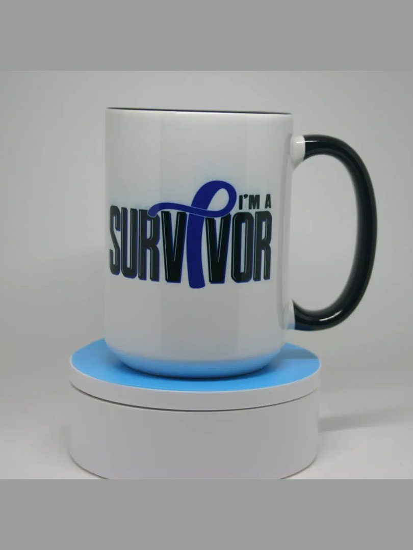 A mug that says i 'm a survivor with a blue ribbon.