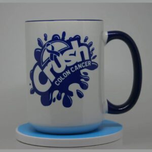 A blue and white mug sitting on top of a coaster.