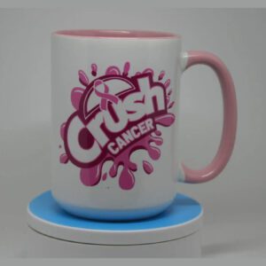 A pink and white mug sitting on top of a blue coaster.