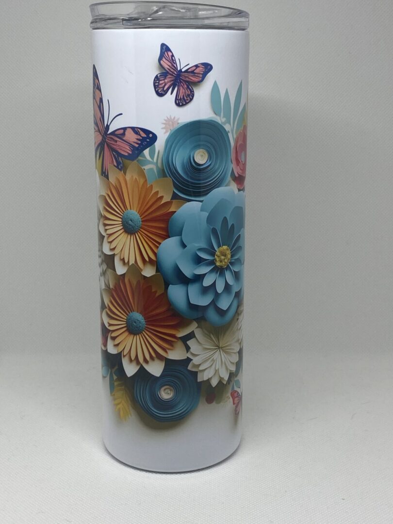 A close up of the vase with flowers and butterflies