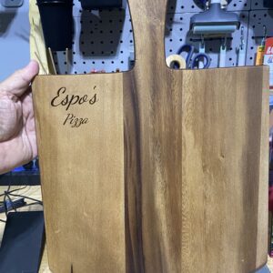 A person holding up a wooden box with the words " espanola mex ".