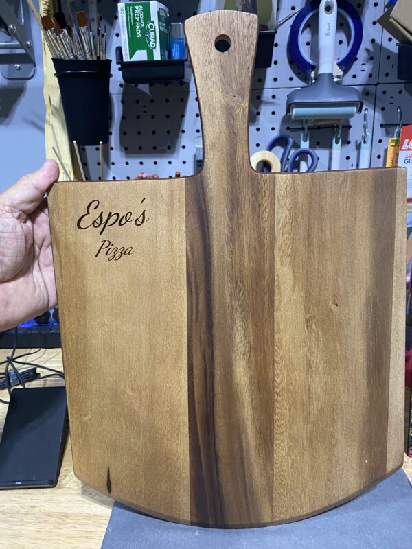 A person holding up a wooden box with the words " espanola mex ".