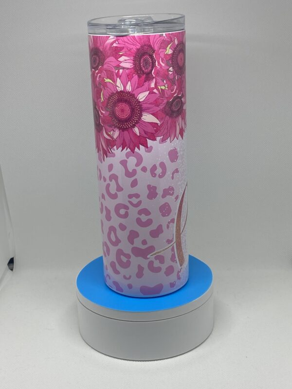 A pink and white vase with flowers on it