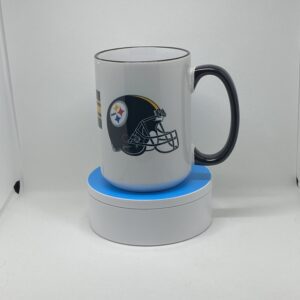 A white coffee mug sitting on top of a blue coaster.