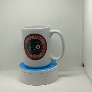 A white coffee mug sitting on top of a blue coaster.