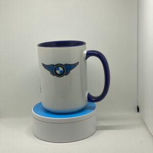 A coffee mug sitting on top of a white and blue cup.