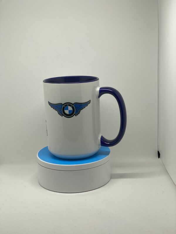 A coffee mug sitting on top of a white and blue cup.