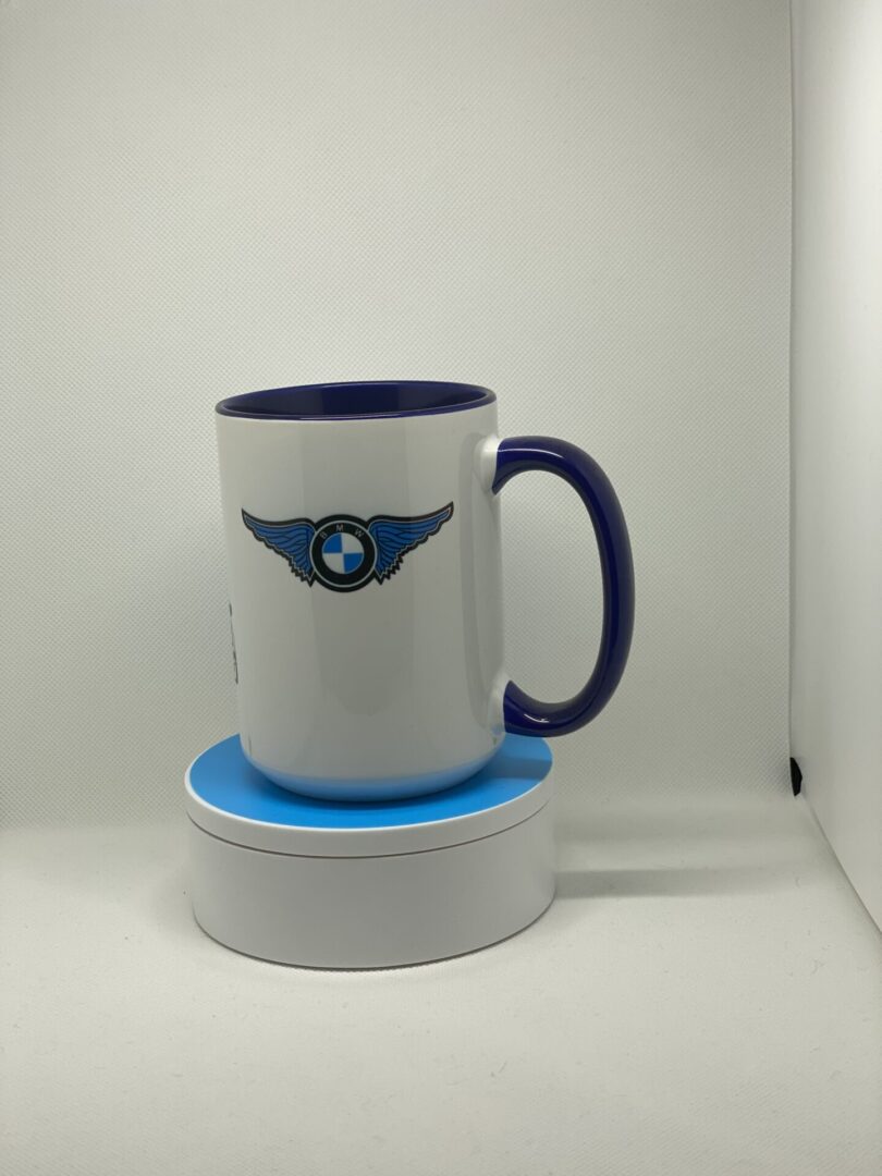 A coffee mug sitting on top of a white and blue cup.