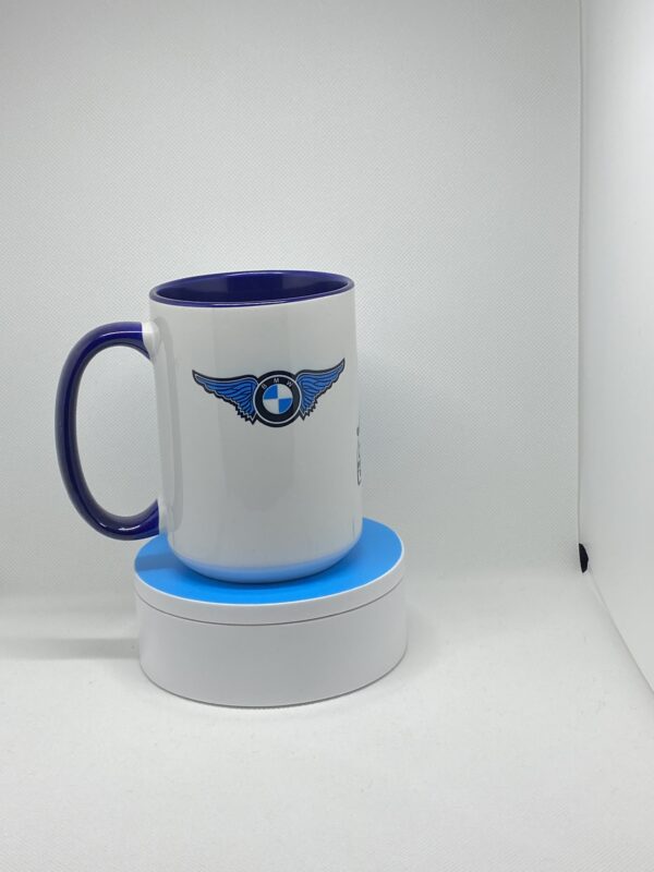 A coffee mug sitting on top of a white and blue cup holder.