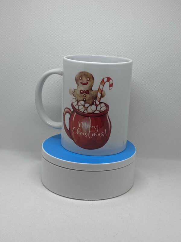 A mug with a teddy bear sitting in the middle of it.