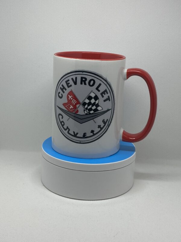 A red and white mug sitting on top of a coaster.