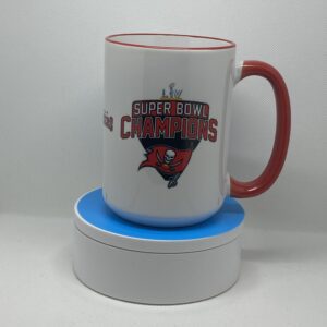 A cup sitting on top of a coaster.