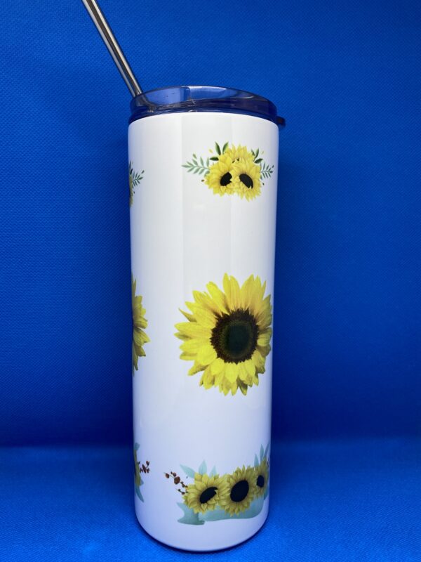 A white cup with sunflowers on it