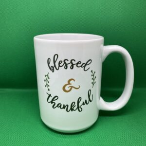 A coffee mug that says blessed and thankful.