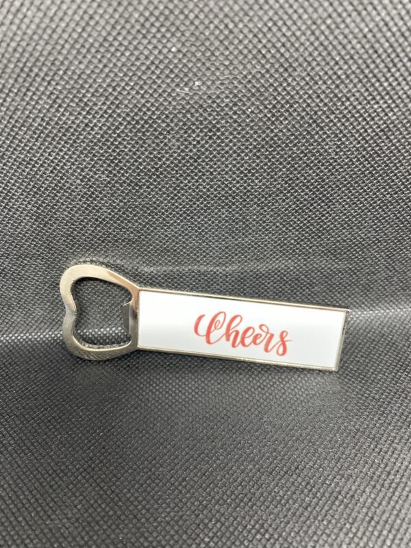 A bottle opener with the word cheers written on it.