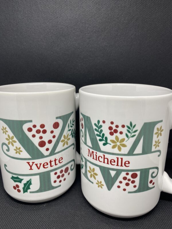 Two mugs with the letters yvette and michelle on them.