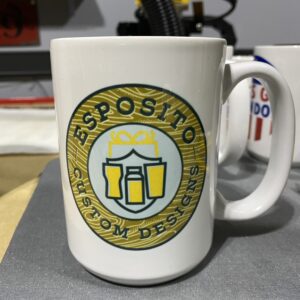 A coffee mug with the name esposito custom designs on it.