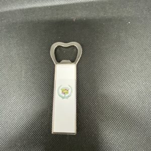 A bottle opener with an apple on it.