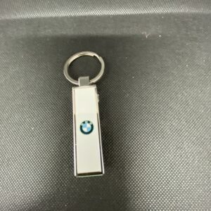 A bmw key chain with the logo of an individual.