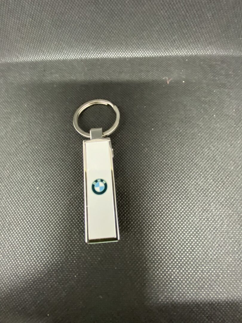 A bmw key chain with the logo of an individual.