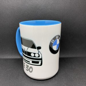 A coffee mug with the bmw logo on it.