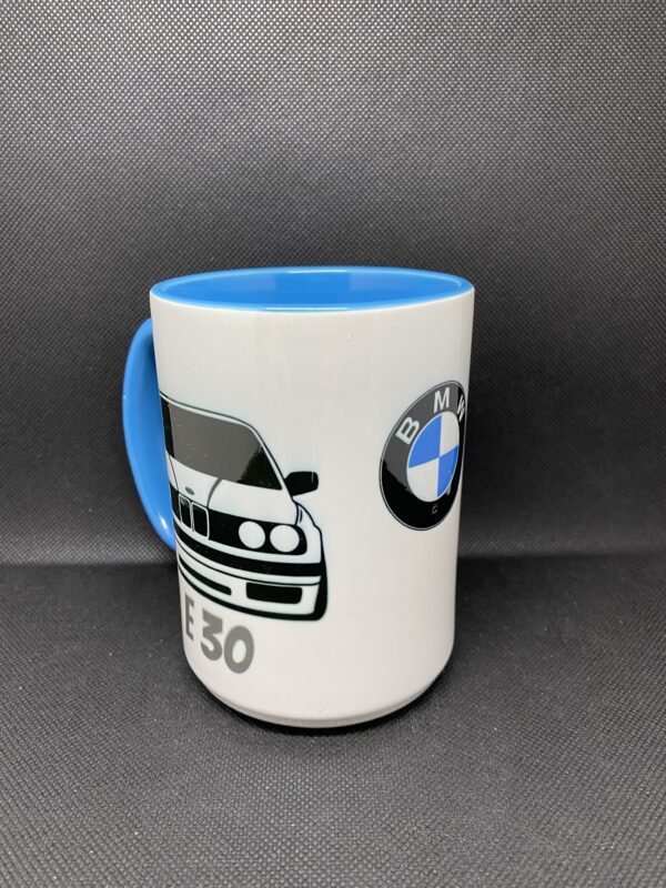 A coffee mug with the bmw logo on it.