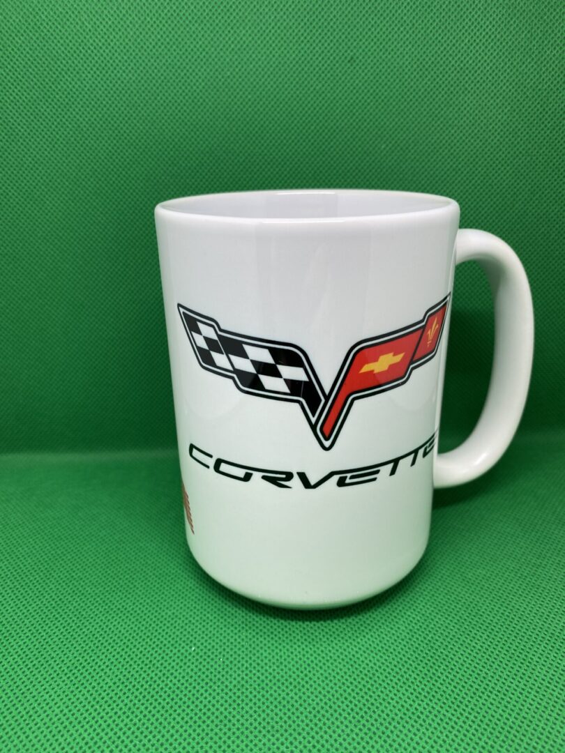 A white coffee mug with the word corvette written on it.