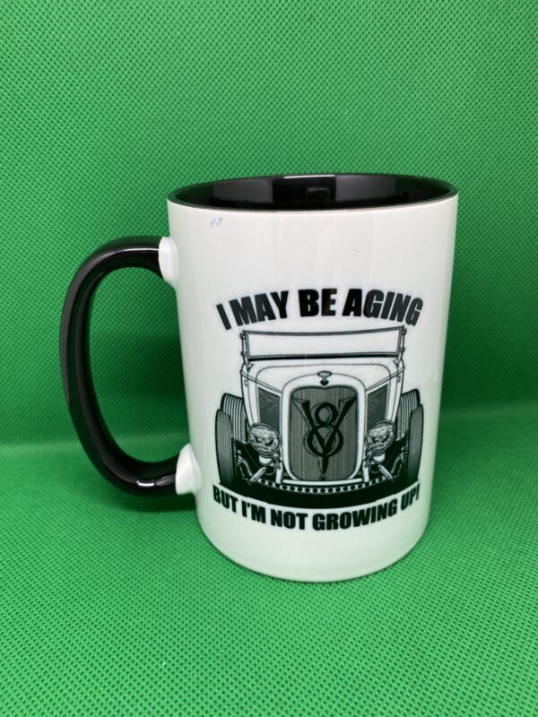 A mug that says i may be aging but i 'm not growing old.