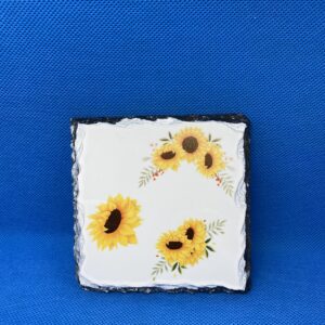 A square tile with sunflowers painted on it.