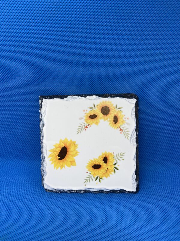 A square tile with sunflowers painted on it.