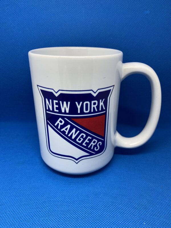 A white mug with the new york rangers logo on it.