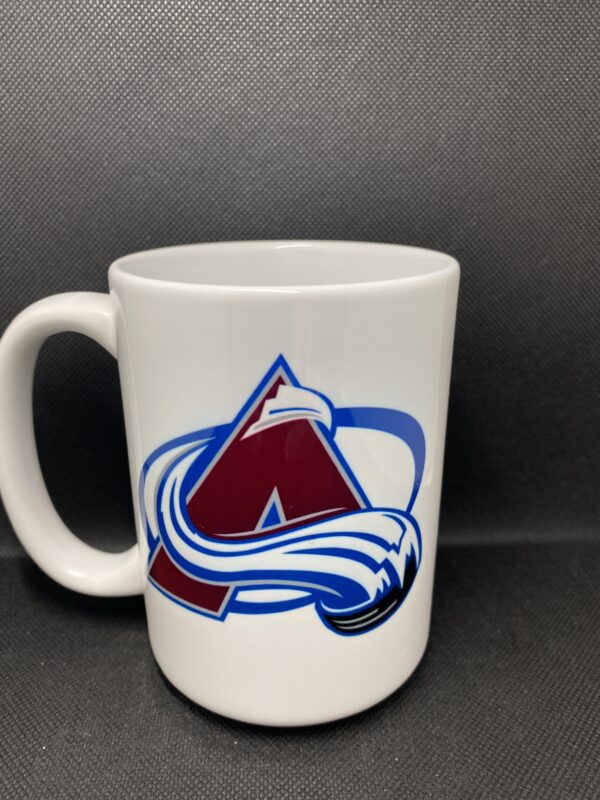 A coffee mug with the colorado avalanche logo on it.