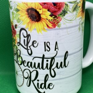 A coffee mug with the words life is a beautiful ride on it.