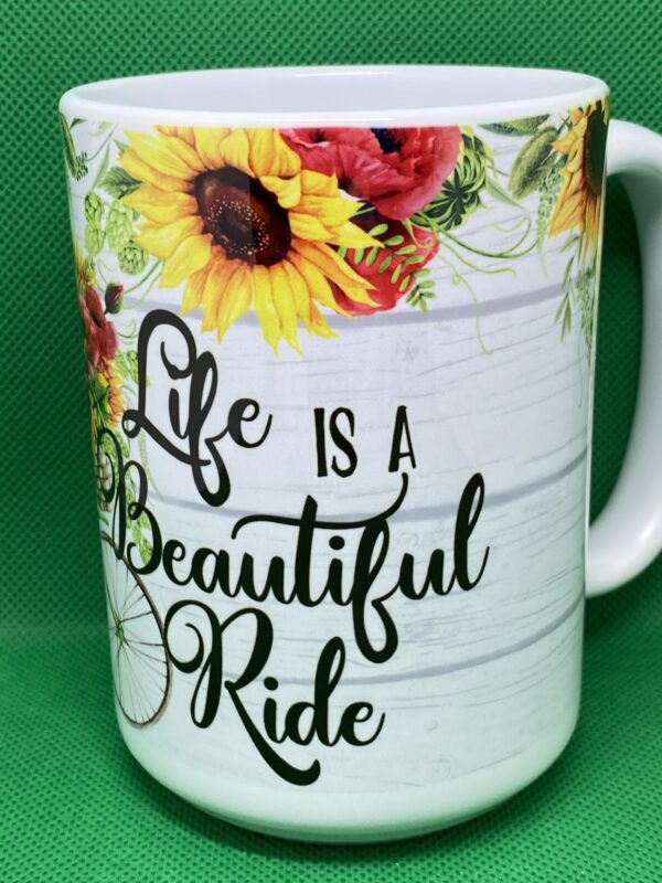 A coffee mug with the words life is a beautiful ride on it.