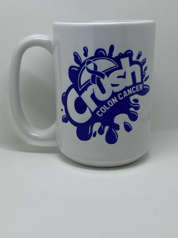 A white coffee mug with the words crush colon cancer on it.