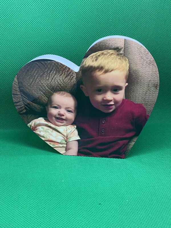 A heart shaped photo frame with two children