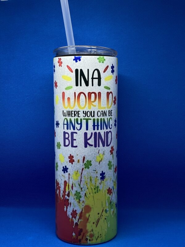 A cup that says " ina world where you can be anything, be kind ".