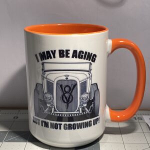 A mug that says i may be aging but i 'm not growing up.