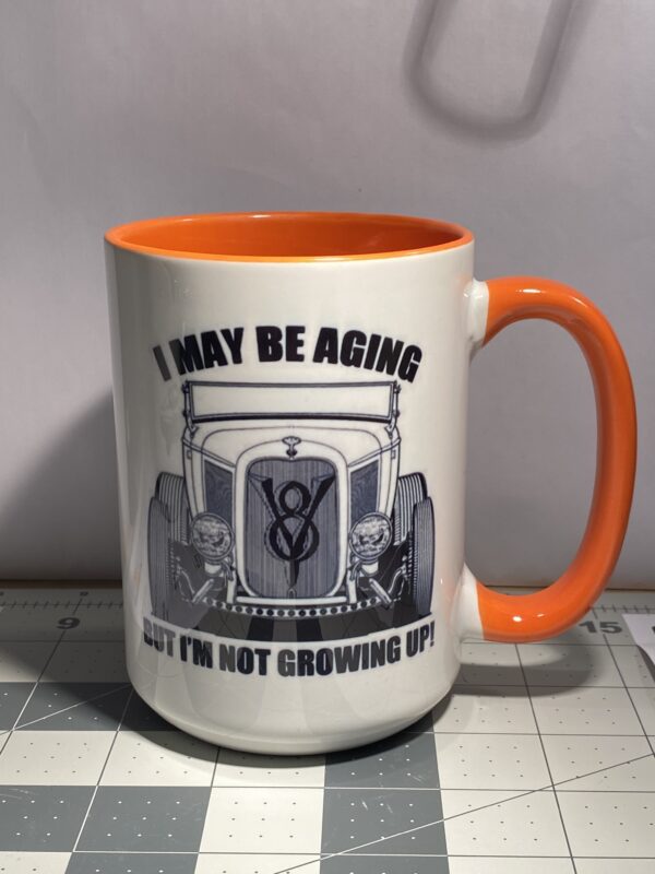 A mug that says i may be aging but i 'm not growing up.