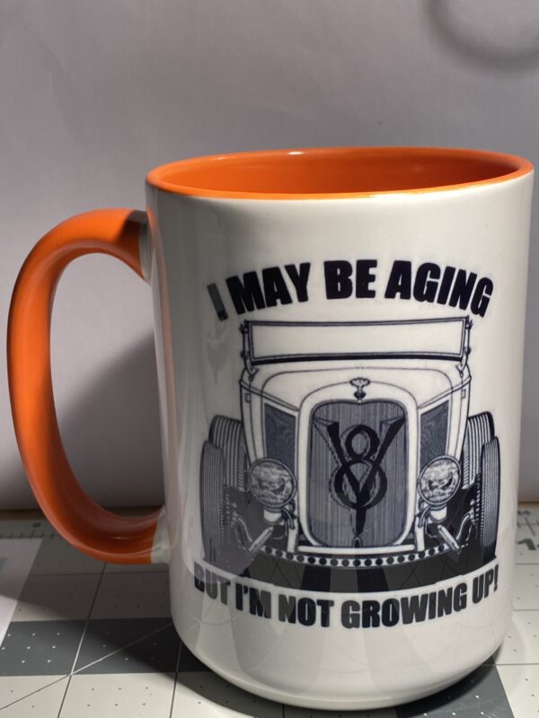 A coffee mug with an old car on it.