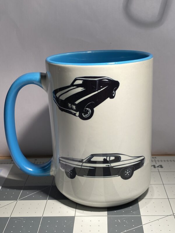 A coffee mug with different cars on it.