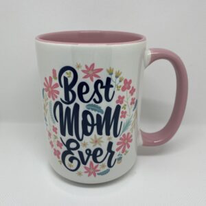 A pink and white coffee mug with the words " best mom ever ".