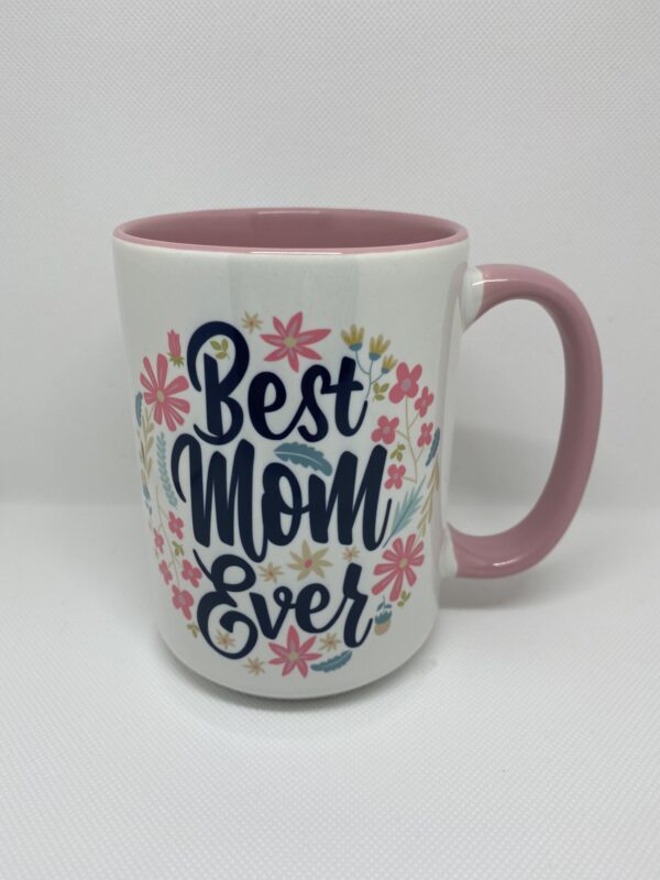 A pink and white coffee mug with the words " best mom ever ".