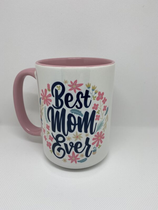 A pink and white coffee mug with the words " best mom ever ".