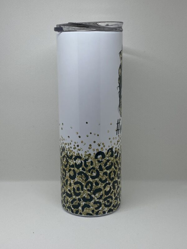 A tall vase with leopard print on it.