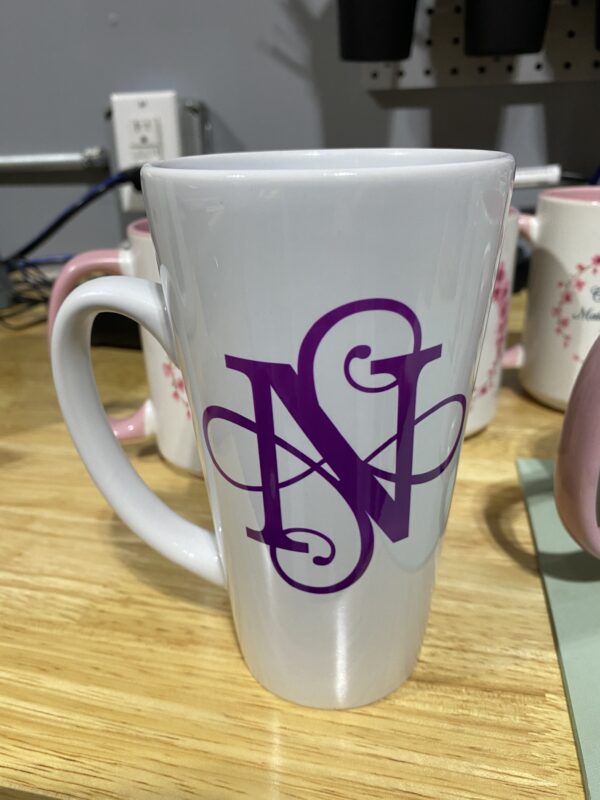 A coffee mug with the letter n on it.