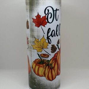 A candle that has fall themed designs on it.