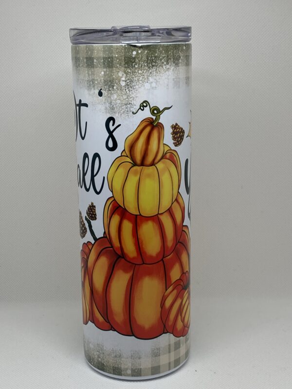 A candle that has pumpkins on it.